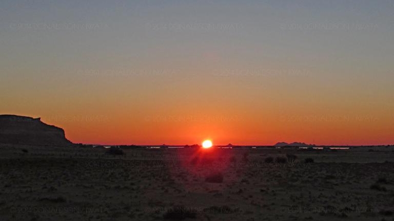 Spring equinox sunrise over the Amun Oracle/Aghurmi viewed from 12km away at Timasirayn temple in Siwa Oasis, Egypt on March 21st 2014.